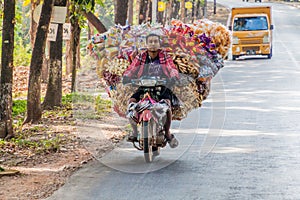 HPA AN, MYANMAR - DECEMBER 13, 2016: Local man on a heavily loaded motorbike near Hpa A
