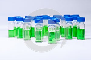 HPLC vials with green sample of plant extracts. Developing of drugs based on natural products. Biochemical analysis