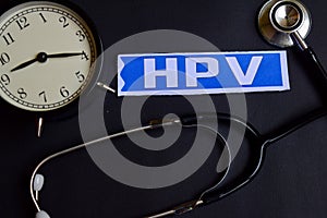 HPV on the paper with Healthcare Concept Inspiration. alarm clock, Black stethoscope.