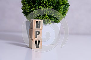HPV word written on wood block. HPV text on table for your desing, Top view concept