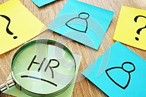 HR human resource written on a stick and magnifier. photo