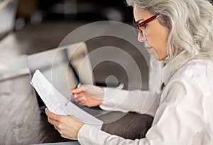 HR Manager Lady Reading Resume Sitting In Office, Side View