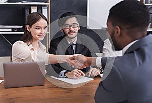 HR manager shaking hands with applicant at interview