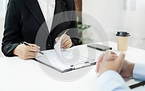 HR Managers hold a resume and talk to job applicants for job interviews about careers and Their personal history in the company.