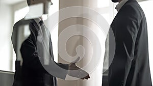 HR officer greeting applicant, job search in large companies, view through glass