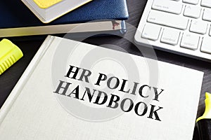 HR policy handbook on a desk. photo
