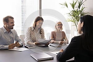HR team of happy employers interviewing Asian job candidate woman