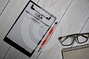 HRA - Health Reimbursement Account write on a paperwork isolated on office desk photo