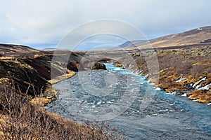 Hraunfossar waterfalls falling with blue water photo