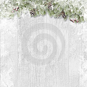 Ð¡hristmas background. Snow firtree with cones and red berry on wooden white board. Greeting holiday card