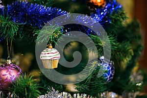 Ð¡hristmas ball in shape of muffin on Christmas tree.