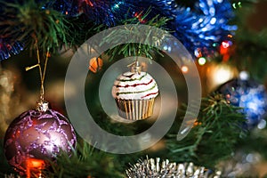 Ð¡hristmas ball in shape of muffin on Christmas tree.