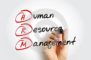 HRM - Human Resource Management is the strategic approach to the effective and efficient management of people in a company or photo