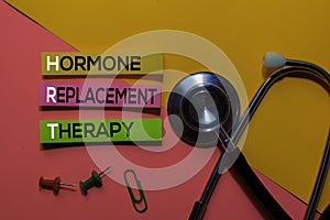 HRT. Hormone Replacement Therapy acronym on sticky notes. Office desk background