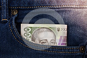hryvnya banknote in jeans pocket