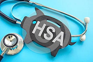 HSA health savings account. Stethoscope and piggy bank.