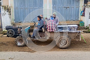 HSIPAW, MYANMAR - DECEMBER 3, 2016: Local people on a tractor in a village near Hsipaw, Myanm