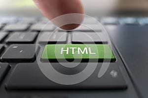 HTML computer language. writing on button modern of gray laptop. Finger presses the button. Programmer for work