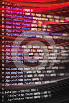 HTML and CSS code and colorful light effects.