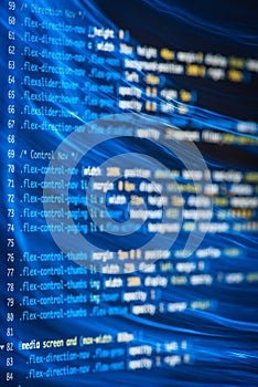 HTML and CSS code and colorful light effects.