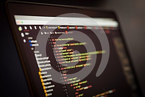 HTML and CSS code on laptop screen.