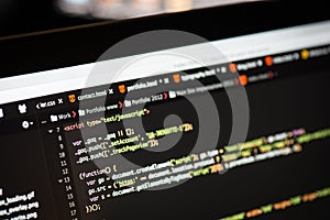 HTML and CSS code on laptop screen.