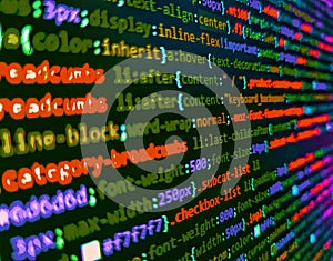 HTML CSS3 source code on lcd screen with black background. Monitor closeup of function source code. Programmer working in a