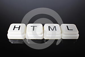 HTML text word title caption label cover backdrop background. Alphabet letter toy blocks on black reflective background. White alp
