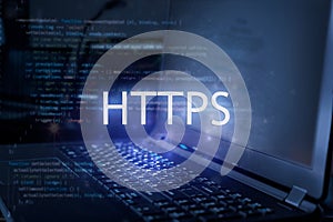 HTTPS inscription against laptop and code background.  Internet security concept