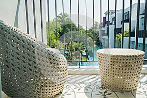 Huahin Thailand - February 2021: silhouette noise and grain rattan chairs with pool view in hotel bedroom