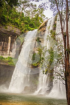 Huai Luang Waterfall, also known as Namtok Huai Luang or Namtok Bak Teo. The waterfall is plunging down three steps from an elevat