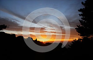 Huangshan Mountain in Anhui Province, China. Sunset over Huangshan with the mountain and foreground tree