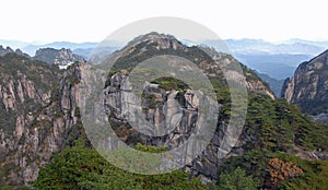 Huangshan Mountain in Anhui Province, China. View of the mountain with peaks, cliffs and pine trees as seen from Flying-Over Rock