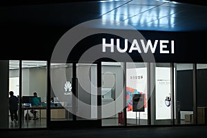 HUAWEI store at night and logo