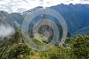 Huayna Picchu, or Wayna Pikchu, mountain in clouds rises over Machu Picchu Inca citadel, lost city of the Incas