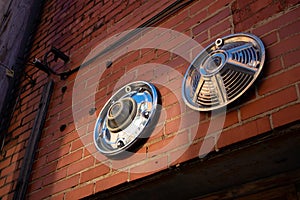 Hub caps mounted on brick wall