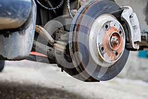 the hub of the front wheel of a jacked car during a tire change