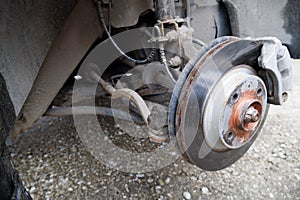 the hub of the front wheel of a jacked car during a tire change