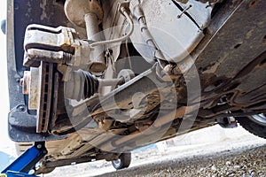 the hub of the front wheel of a jacked car during a tire change