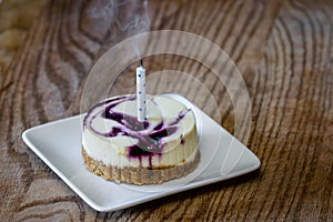 Huckleberry cheesecake with a candle