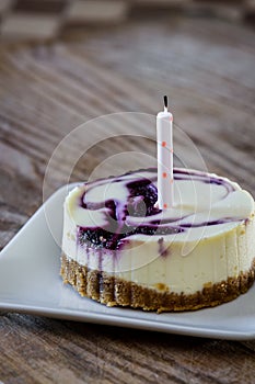 Huckleberry cheesecake with a candle