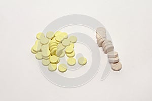 Huddle of yellow tablets with parting lines and broken stack of