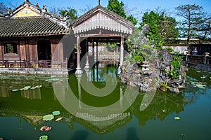 Hue, Vietnam, the imperial citadel. View of a palace water and rock garden with bonsai trees.