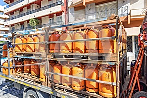 Huelva, Spain - May 10, 2022: A truck delivering orange butane bottles from the Repsol company