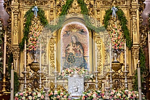 Huelva, Spain - September 8, 2020: Altar of the sanctuary Virgen de la Cinta on the day of her festivity, with bouquets of flowers