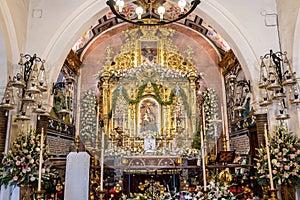 Huelva, Spain - September 8, 2020: Altar of the sanctuary Virgen de la Cinta on the day of her festivity, with bouquets of flowers