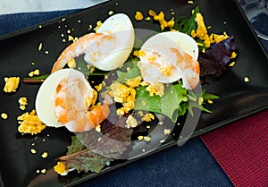 Huevos mimosa con gambas, eggs with prawns and salad photo
