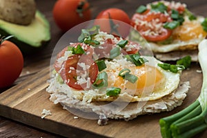 Huevos rancheros tostadas with avocado salsa photo