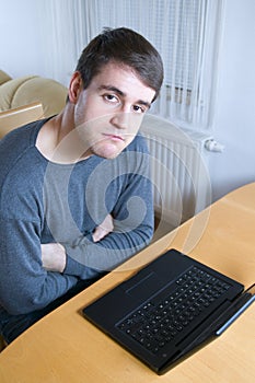 Huffing man at the laptop photo