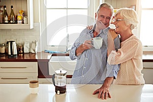 Hug, coffee or happy old couple in kitchen at home bonding or enjoying quality morning time together. Embrace